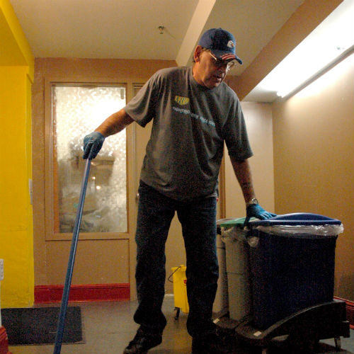 A Fresh Start employee cleaning a hallway